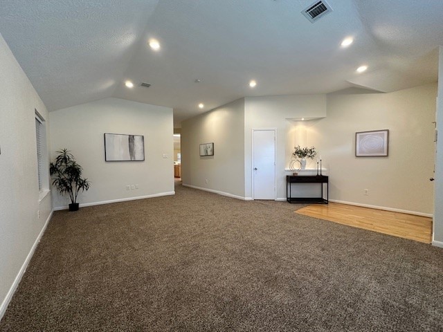 carpeted spare room with lofted ceiling, visible vents, baseboards, and recessed lighting