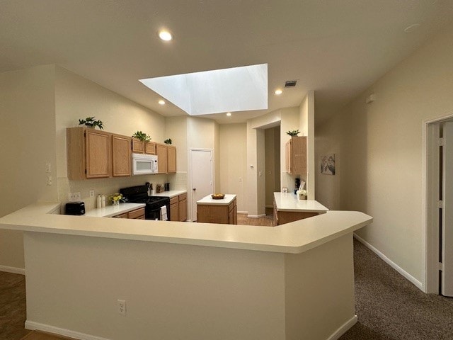 kitchen with a skylight, light countertops, visible vents, black gas range, and white microwave