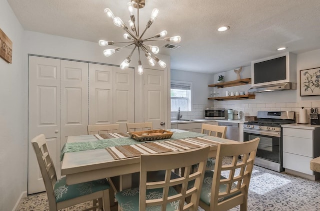 dining room with a textured ceiling, visible vents, a notable chandelier, and recessed lighting