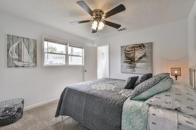 carpeted bedroom featuring baseboards, visible vents, ceiling fan, and a textured ceiling