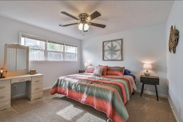 bedroom featuring a ceiling fan, light colored carpet, a textured ceiling, and baseboards