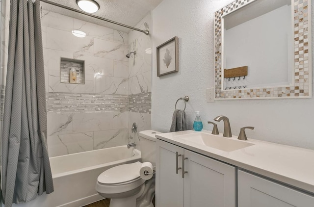 bathroom featuring shower / bath combo, a textured wall, toilet, a textured ceiling, and vanity