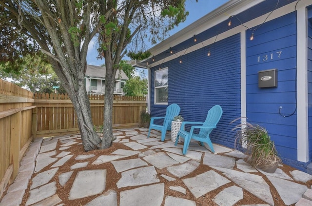 view of patio / terrace featuring fence