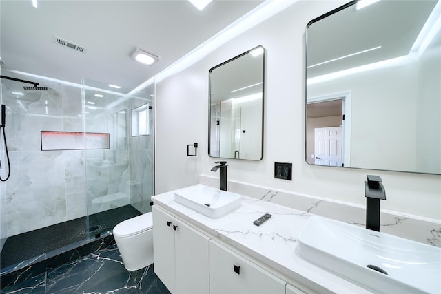 bathroom with a stall shower, marble finish floor, a sink, and toilet