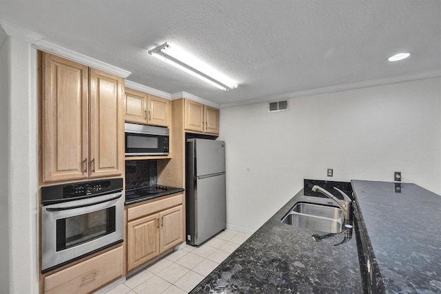 kitchen featuring light tile patterned floors, visible vents, dark stone countertops, stainless steel appliances, and a sink