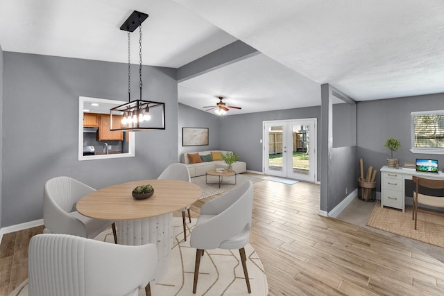 dining room featuring french doors, lofted ceiling, light wood-style floors, ceiling fan, and baseboards