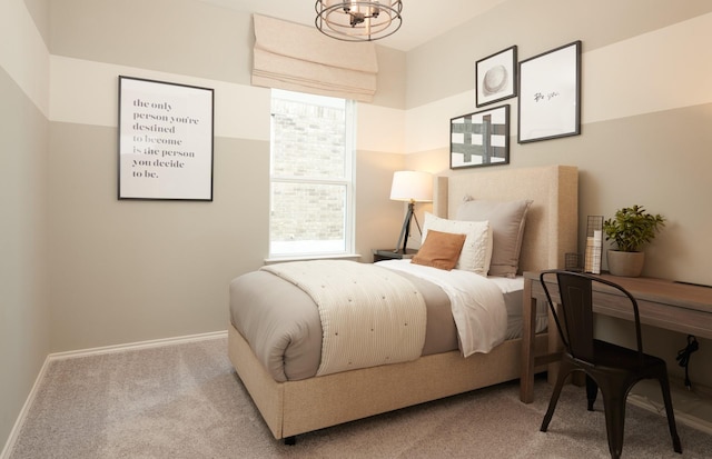 carpeted bedroom featuring a chandelier, multiple windows, and baseboards