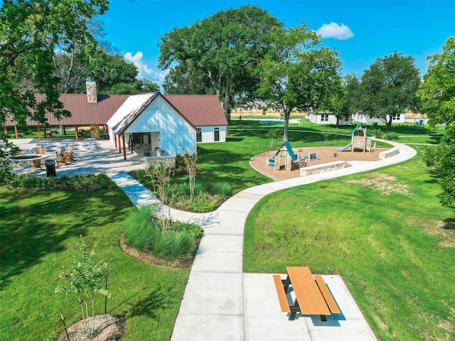 view of community featuring a lawn and playground community