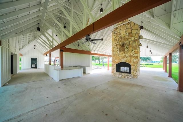 view of patio featuring an outdoor stone fireplace and a ceiling fan