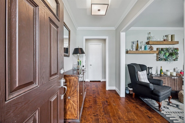 foyer featuring baseboards, ornamental molding, and dark wood finished floors