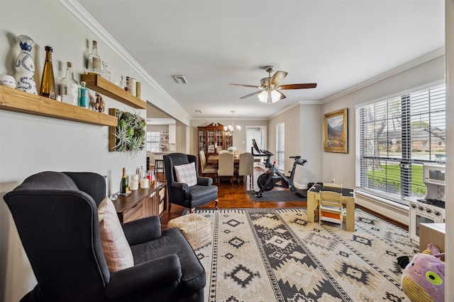 living area featuring ceiling fan with notable chandelier, crown molding, and wood finished floors