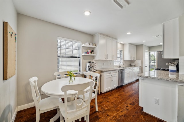 kitchen featuring tasteful backsplash, white cabinets, dishwasher, dark wood-type flooring, and open shelves