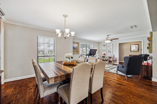 dining space featuring baseboards, visible vents, dark wood-style floors, crown molding, and ceiling fan with notable chandelier