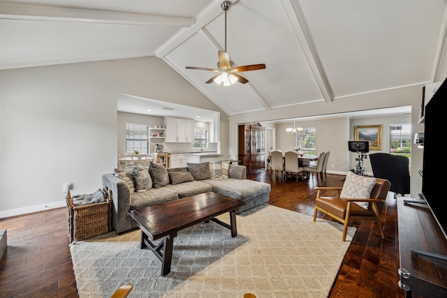 living room featuring ceiling fan with notable chandelier, beamed ceiling, wood-type flooring, and baseboards