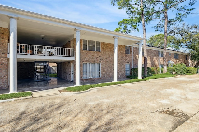 exterior space with concrete driveway and stairs