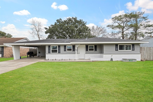 ranch-style house with brick siding, concrete driveway, fence, an attached carport, and a front lawn