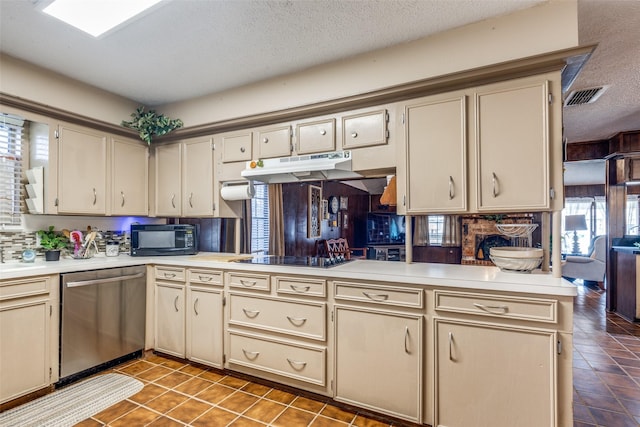 kitchen with cream cabinets, under cabinet range hood, visible vents, light countertops, and black appliances