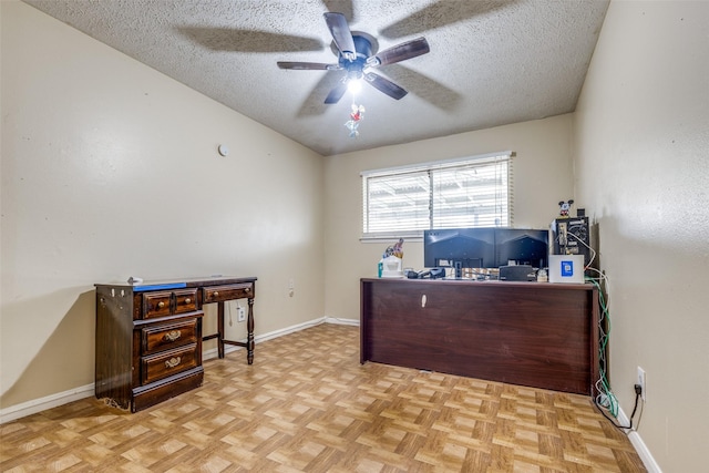 office featuring a textured ceiling, ceiling fan, and baseboards