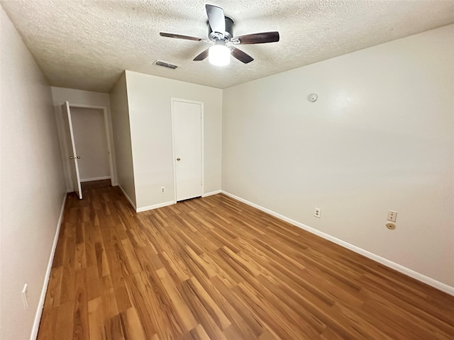11439 Sageking Dr, Houston, TX 77089 - unfurnished bedroom featuring light wood-type flooring, baseboards, a textured ceiling, and ceiling fan