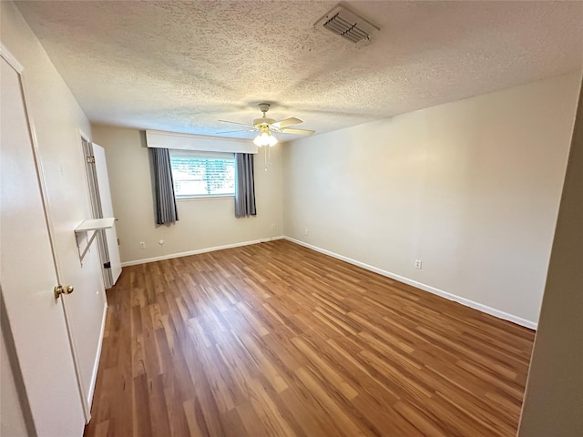 11439 Sageking Dr, Houston, TX 77089 - empty room featuring a ceiling fan, a textured ceiling, wood finished floors, and baseboards