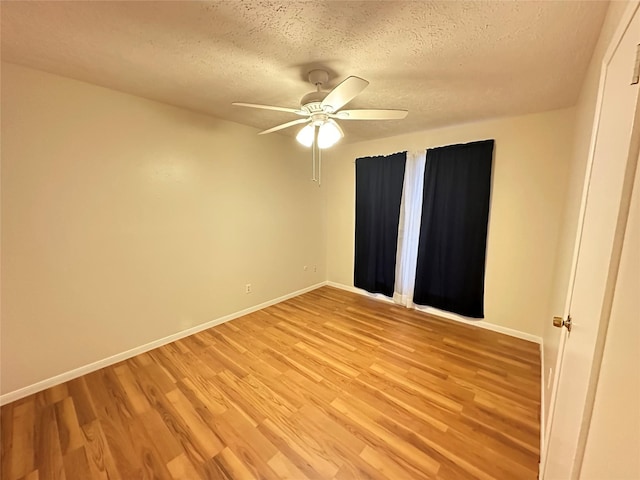 11439 Sageking Dr, Houston, TX 77089 - spare room featuring light wood-type flooring, ceiling fan, baseboards, and a textured ceiling