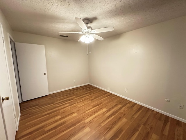 11439 Sageking Dr, Houston, TX 77089 - unfurnished room featuring wood finished floors, ceiling fan, baseboards, and a textured ceiling