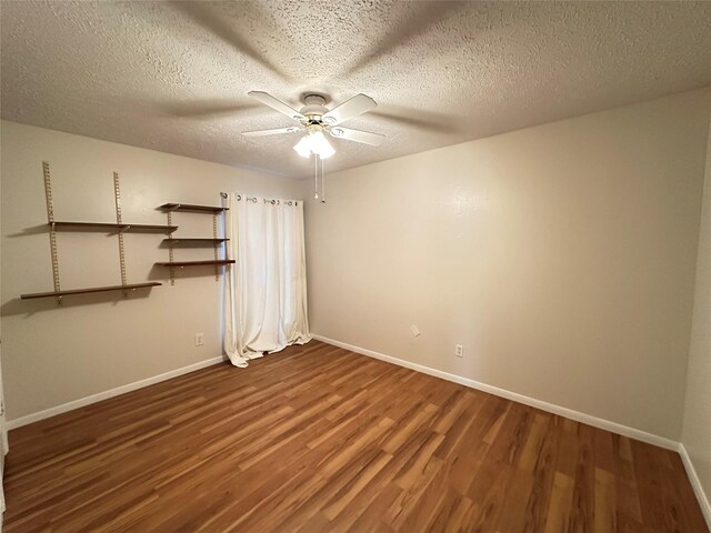 11439 Sageking Dr, Houston, TX 77089 - empty room with wood finished floors, a ceiling fan, baseboards, and a textured ceiling
