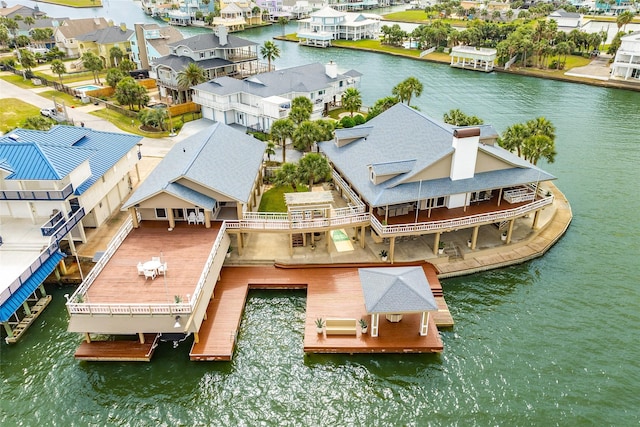 birds eye view of property featuring a water view and a residential view