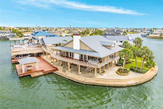 rear view of house featuring a water view, a residential view, and central air condition unit