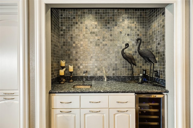 bar with wet bar, beverage cooler, a sink, and decorative backsplash