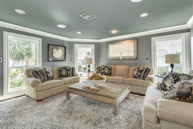 living area featuring ornamental molding, visible vents, and recessed lighting