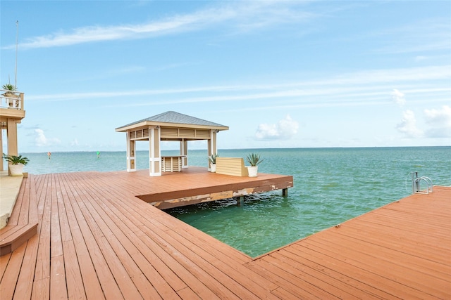 view of dock with a water view and a gazebo