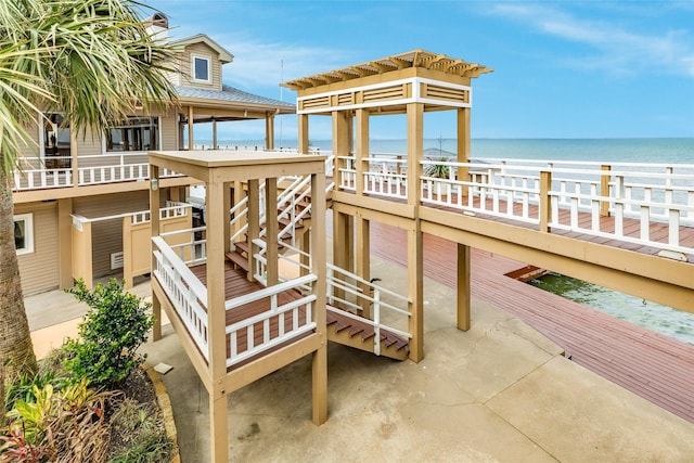 surrounding community featuring stairs and a water view