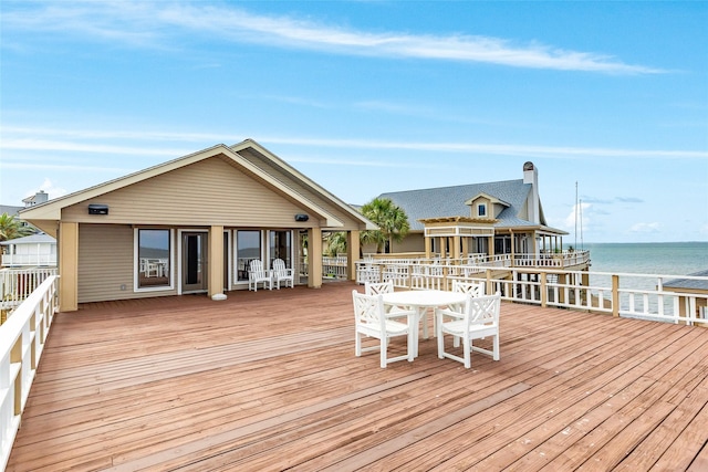 wooden terrace featuring a water view