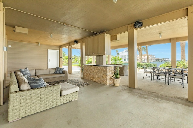 view of patio / terrace with outdoor dining area, an outdoor living space, and exterior kitchen