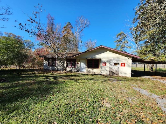 rear view of house featuring a yard