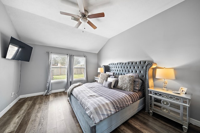 bedroom featuring lofted ceiling, wood finished floors, a ceiling fan, and baseboards