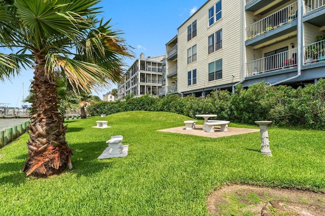 surrounding community featuring a patio and a lawn