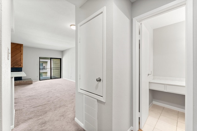 corridor with carpet floors and baseboards