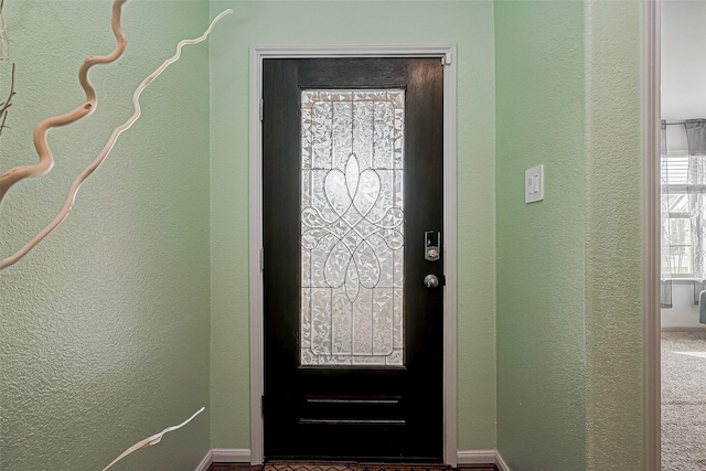 foyer entrance with a textured wall