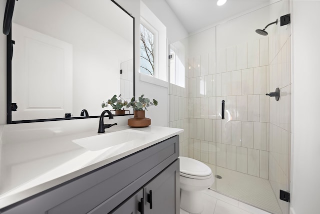 bathroom with tile patterned flooring, a shower stall, toilet, and vanity