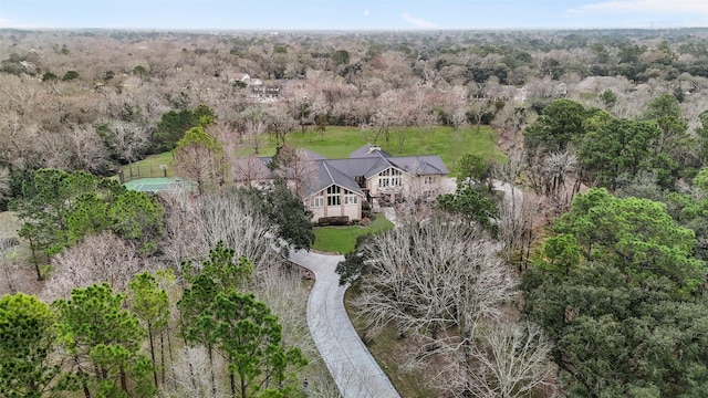 bird's eye view with a wooded view