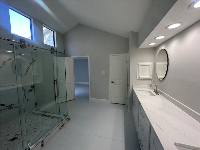 bathroom with vanity, baseboards, vaulted ceiling, a marble finish shower, and tile patterned floors