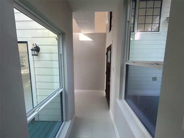 interior space with tile patterned flooring and baseboards