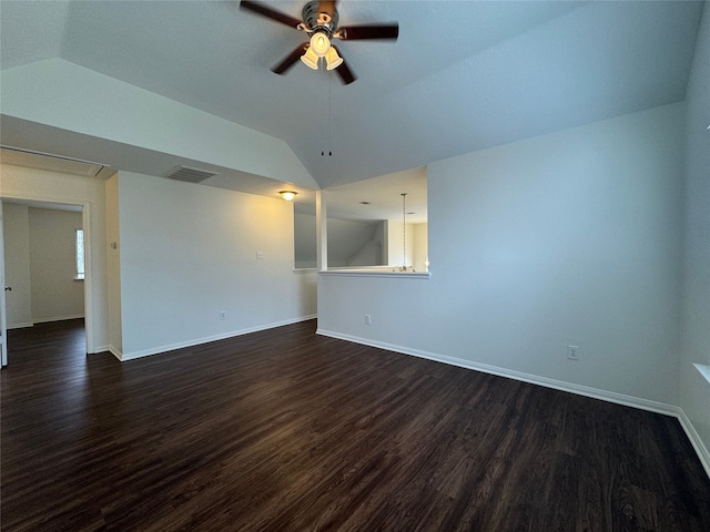 unfurnished room with dark wood-style floors, visible vents, a ceiling fan, vaulted ceiling, and baseboards