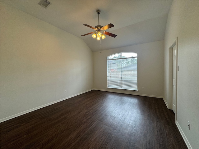 unfurnished room with vaulted ceiling, dark wood finished floors, visible vents, and baseboards