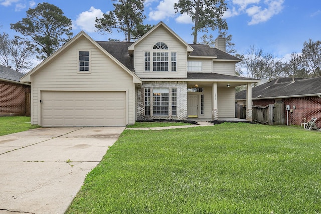 traditional-style house with brick siding, fence, a front yard, a chimney, and driveway