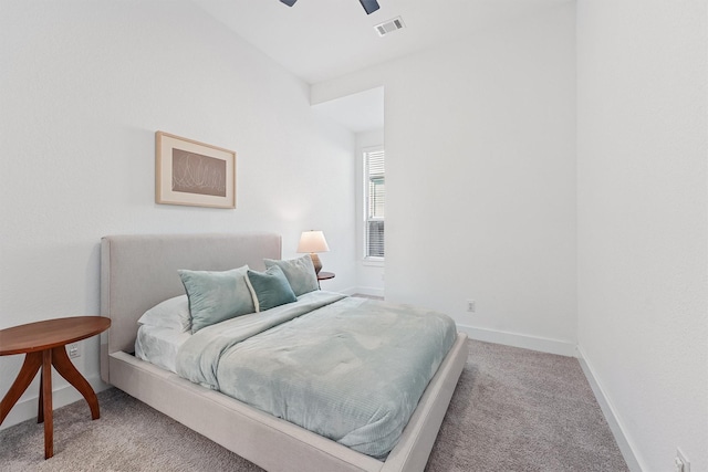 carpeted bedroom featuring baseboards, visible vents, and ceiling fan