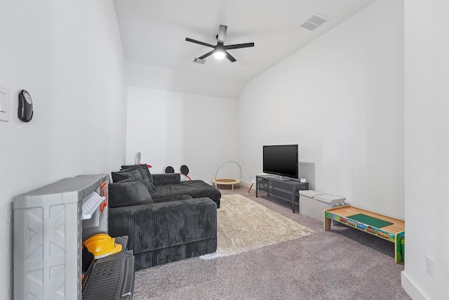 living area with visible vents, vaulted ceiling, carpet flooring, and ceiling fan