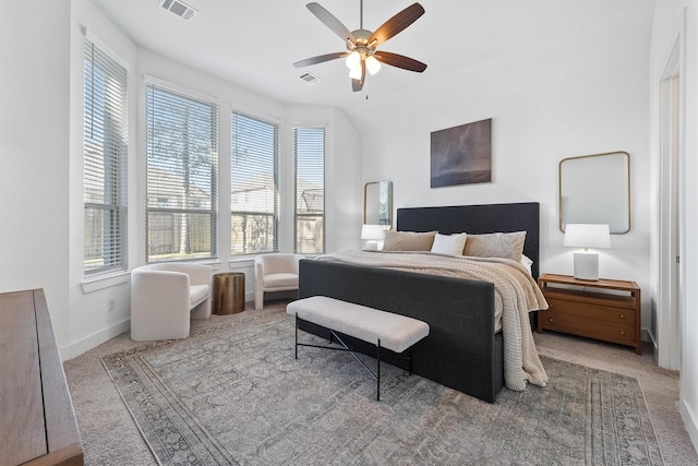 carpeted bedroom featuring ceiling fan, visible vents, and baseboards